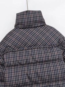 Detail of classic plaid puffer jacket with stand collar and horizontal quilting on the back