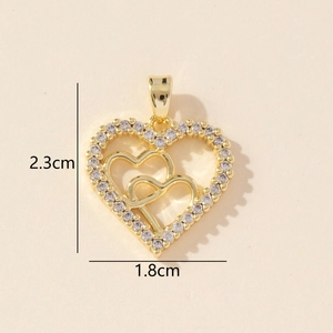 Macro detail of gold-tone heart pendant with cubic zirconia and size measurements