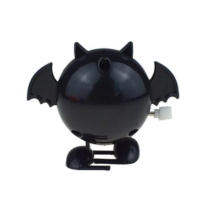 Macro view of mechanical clockwork knob on a black bat-shaped wind-up walking toy
