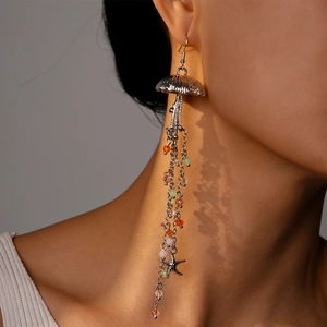 Detailed shot of long silver tassel earrings with colorful beads and a starfish charm