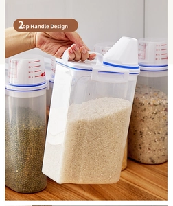 Detail of transparent storage jar featuring a white handle lid and integrated measuring cup