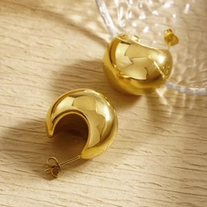 Polished gold stainless steel chunky C-shape hoop earrings on textured background