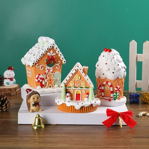 Three assorted gingerbread house ornaments for Christmas decor with festive figurines