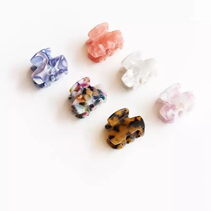 Set of 6 mini acetate hair claw clips in various colorful marble and floral patterns