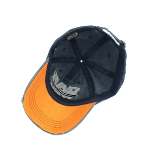 Navy washed cotton baseball cap with orange brim underside and embroidered detail