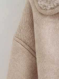 Macro view of light beige suede fabric texture and white faux sheepskin fleece lining