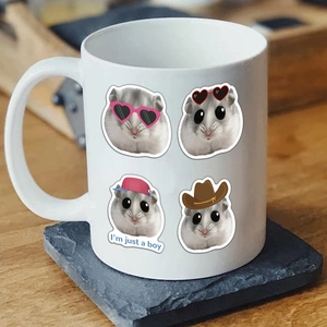 Macro view of white ceramic mug featuring cute cartoon hamsters and I'm just a boy text