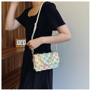 Détail du sac bandoulière en tweed coloré avec chaîne blanche et sangle réglable