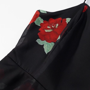 Detail of floral print chiffon dress with red roses and delicate spaghetti straps