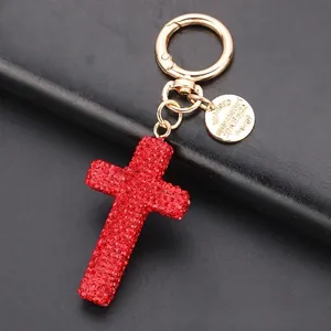Sparkling red rhinestone cross keychain with golden alloy ring and classic leather cord