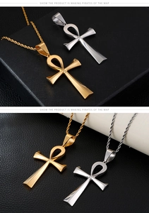Polished stainless steel gold and silver Ankh cross pendants on a black leather texture