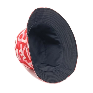 Detailed top view of reversible bucket hat with red letter print and solid black interior