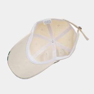 Beige cotton baseball cap interior view with 100% cotton label and adjustable strap