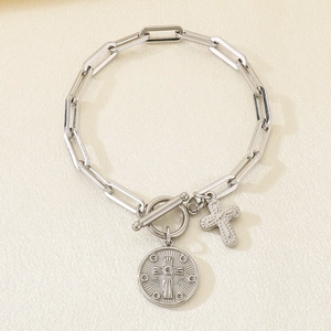 Detail of silver OT toggle bracelet with cross pendants and paperclip chain link