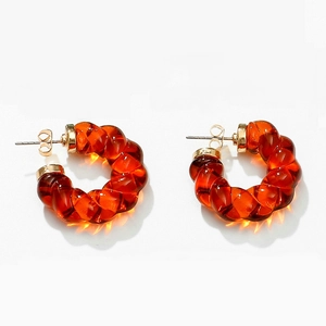 Minimalist amber resin C-shape hoop earrings with gold metal posts on white background