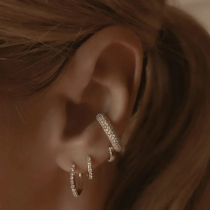 Close-up of S925 sterling silver ear cuff and double-row zircon hoop earrings on ear