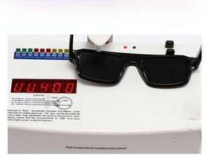 Testing UV400 protection on black square sunglasses with a professional UV detector