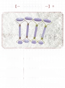 Detailed view of lavender resin facial roller massager with gold metal components