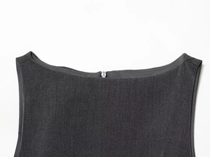 Detailed macro view of the dark grey mini dress neckline and back metal zipper closure