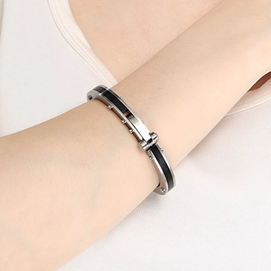 Close-up of punk style stainless steel bangle with black carbon fiber inlay on wrist