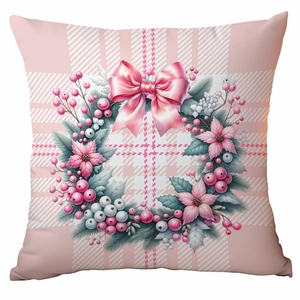 Close-up of pink Christmas wreath pillow cover with a bow and berries on plaid background