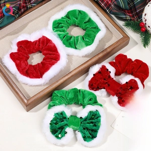 Close-up of velvet Christmas hair scrunchies with faux fur trim and sequin bows on a tray