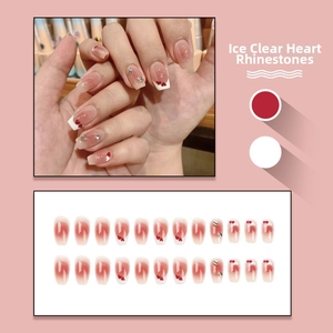 Detail view of 24pcs pink gradient press-on nails with heart patterns and rhinestones