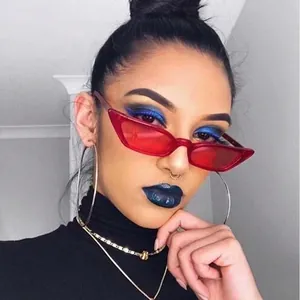 Vintage cat-eye sunglasses with red transparent frames and punk-style jewelry accessories