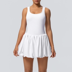 Detail of white cooling tennis dress featuring a pleated bubble hem and sleek racerback