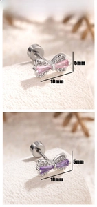Macro detail of bow-shaped zircon earrings in pink and purple colors with dimensions
