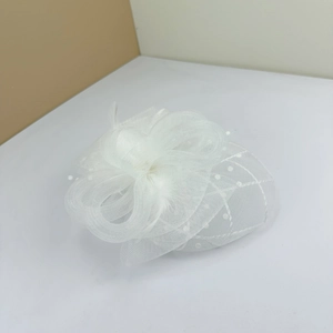 Elegant white fascinator hat with polka dot veil and feathers for wedding party