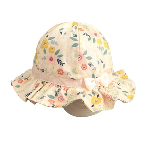 Infant girl floral cotton bucket hat with pink ribbon and white bow on white background