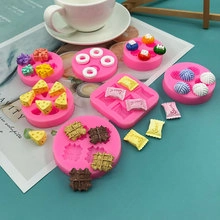 Pink silicone molds for mini waffles and donuts shown with coffee on a table