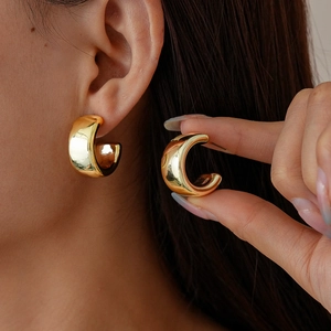 Polished golden geometric C-shaped waterdrop stud earrings for women with a sleek metal finish