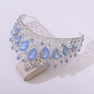 Macro side view of silver wedding crown with blue pear crystals and rhinestones