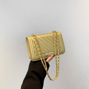 Champagne gold quilted crossbody bag with chain strap and metal lock closure for women