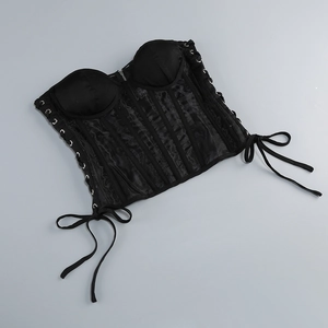 Detail of black corset top featuring sheer mesh paneling and side lace-up design