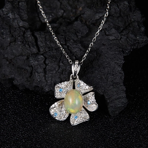 Elegant silver flower pendant necklace with opal center and blue cubic zirconia stones