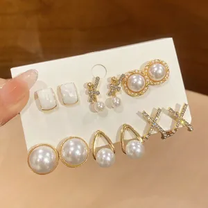 Detail of vintage French style pearl and rhinestone stud earring set on display card