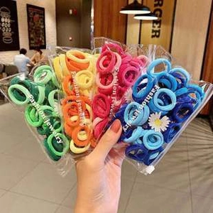 Close-up of assorted colorful high-elastic nylon hair ties in clear packaging bag