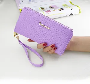 Detail of purple faux leather long wallet with diamond texture and gold logo