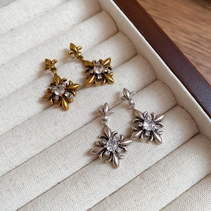 Vintage zircon iris flower drop earrings in gold and silver finish in a jewelry box