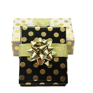 Elegant gold foil polka dot gift wrapping paper set with ribbons and metallic bows