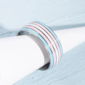 Close-up of rainbow enamel stripes on a polished stainless steel band ring