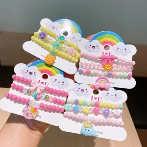 Kids acrylic beaded bracelets with cartoon charms on colorful rainbow card packaging