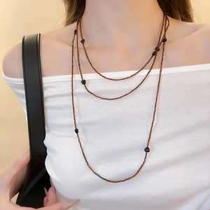 Close-up of layered acrylic heart beaded necklace with brown translucent beads for women