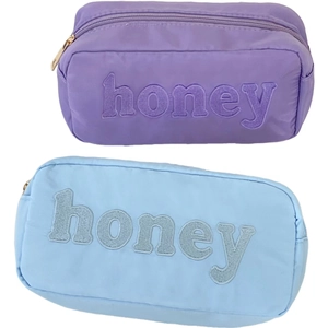 Set of nylon cosmetic bags with honey embroidery and gold zipper in purple and blue