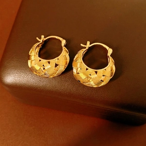 Elegant 18k gold plated U-shaped crossover hoop earrings on a leather jewelry box