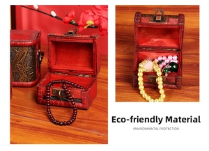 Macro shot of vintage wooden jewelry box with antique metal clasp and soft red velvet lining