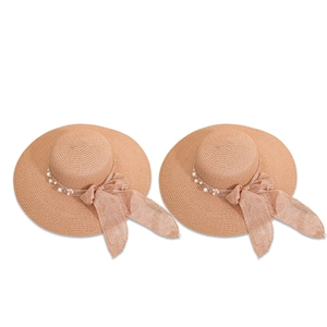 Women's wide brim straw sun hat with floral bow accent and pearl detail for summer travel
